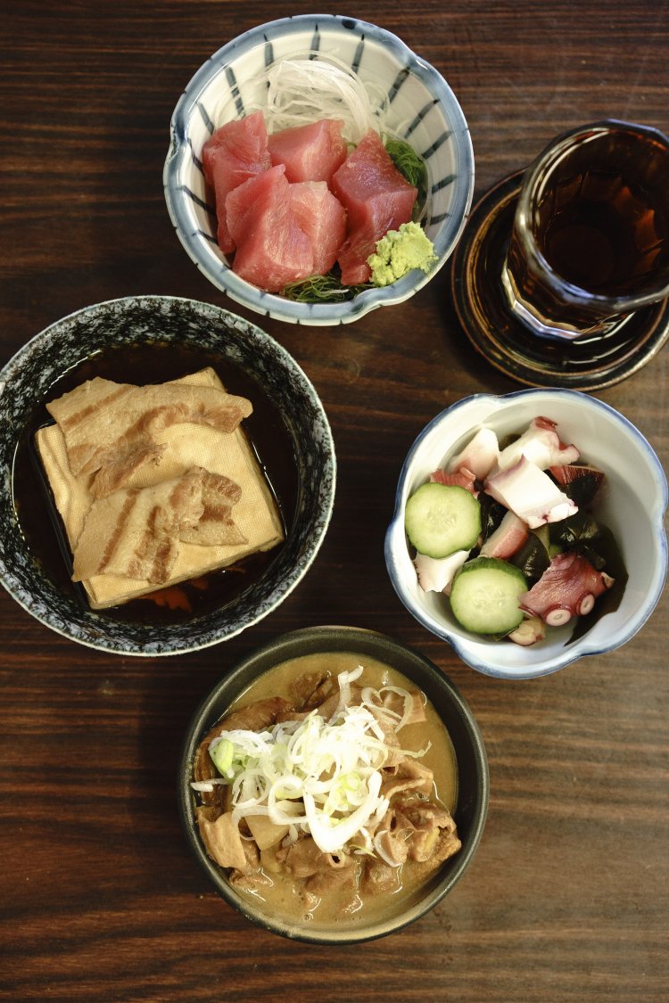 上から時計回りに、まぐろぶつ360円、梅割、わかめときゅうりの酢の物280円、『いづみや』名物のもつ煮込み170円、そして肉豆腐。