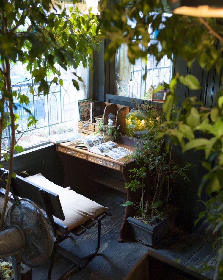 水槽や地球儀などが置かれる、好みの木製ライティングデスクで読み書きして。