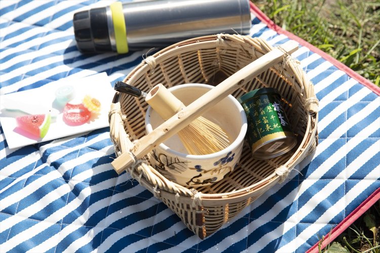 茶筅、茶碗、抹茶はカゴにまとめて。干菓子、熱湯を入れた保温ボトル、シートも準備。