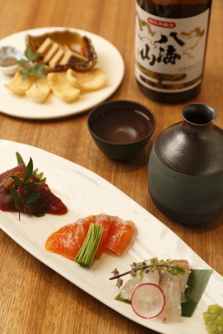 麹漬けお刺身3種盛り合わせ1080円は、醤油麹でマグロを、塩麹で白身魚や八海山サーモンを漬けたもの。八海山ねり粕使用 クリームチーズの味噌漬け702円、特別本醸造の燗。