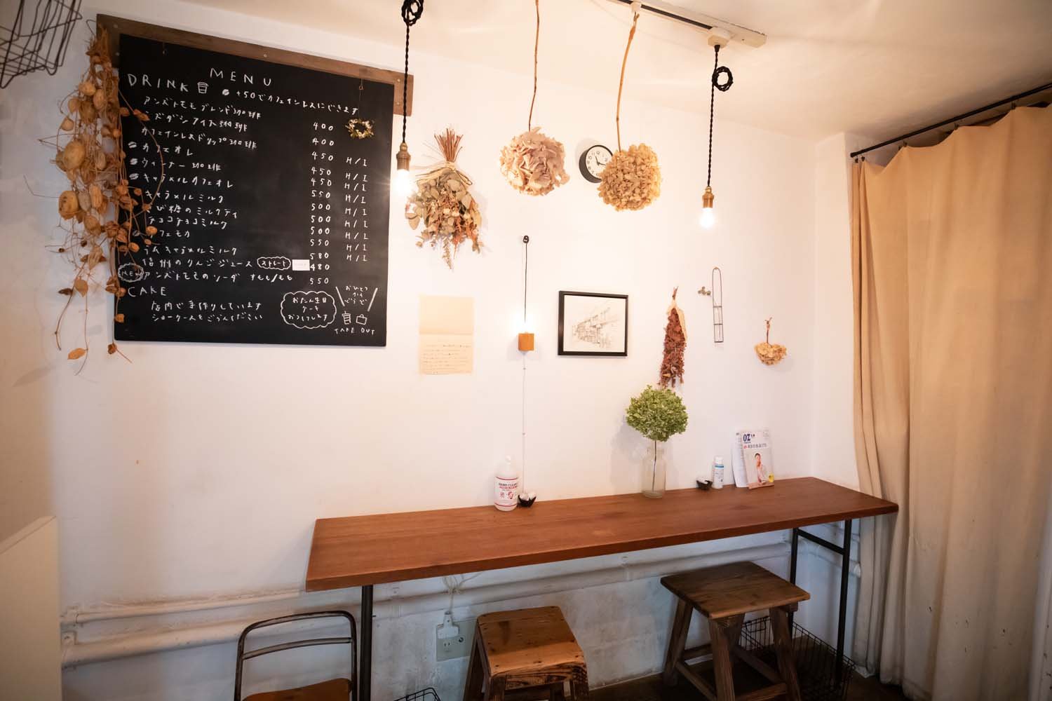 壁際のカウンター席。白壁を暖色の電球が照らす