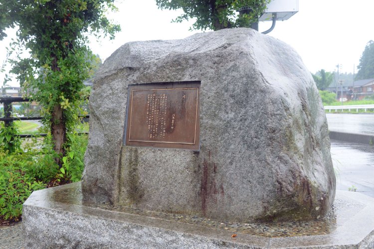 司馬の直筆が刻まれた峠の碑。激戦地の榎峠と朝日山を望んで立つ。