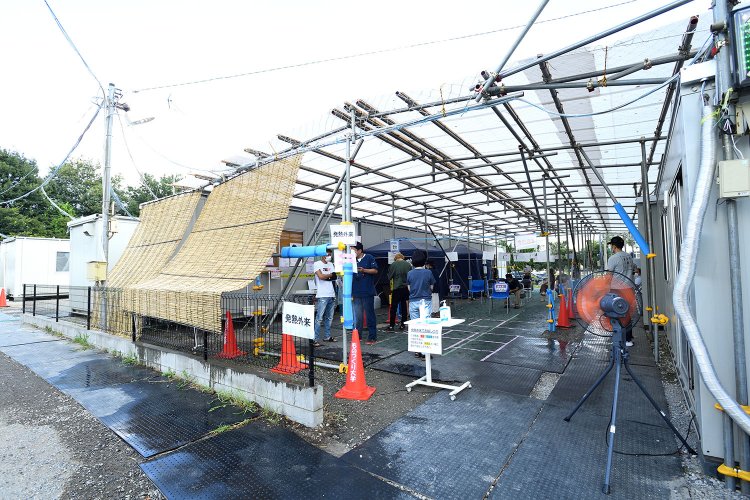 大型扇風機や散水機が置かれ、防護服姿の医療従事者が行き交う「発熱外来」。もちろんPCR検査もここで行う。