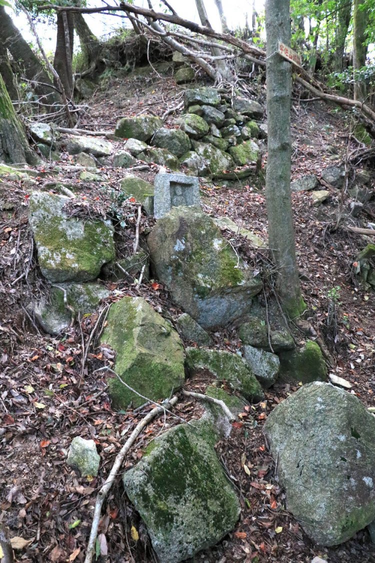 石垣の合間に地蔵がたたずんでいた。