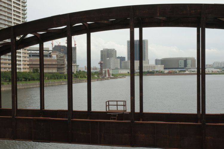 アーチ越しにららぽーと豊洲を見る。このアーチは「下路式ローゼ桁」という種類で、1957年に竣工した。