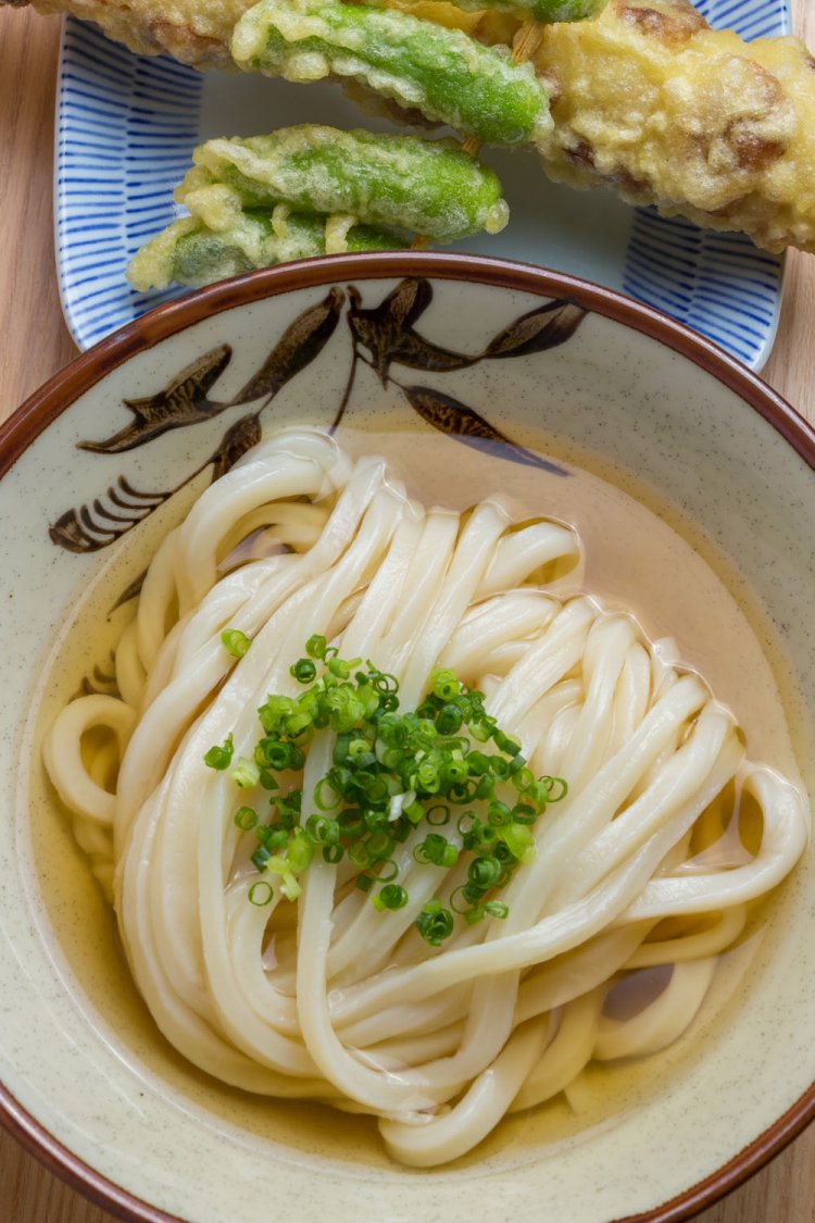 出汁の風味も味わいたい、ひやあつうどん並300円。丸々1本のちくわ天100円は揚げたてで提供。うどん大盛りは400円均一。
