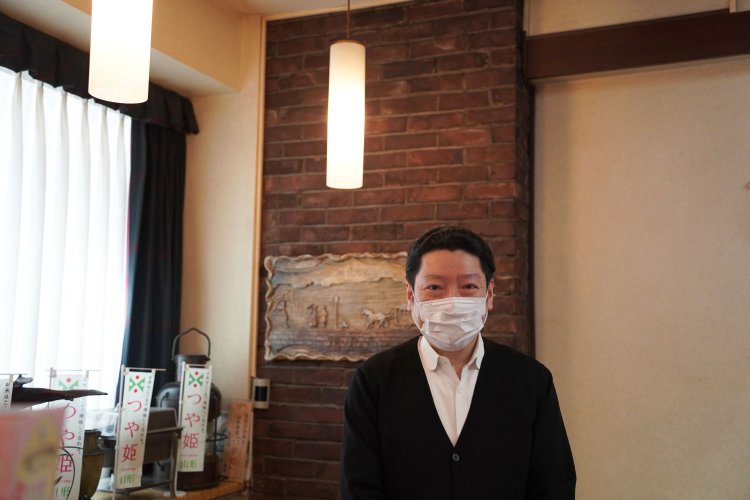 店主の木田浩一朗さん。1階の壁には銀座煉瓦街で使われていた煉瓦が飾られている。