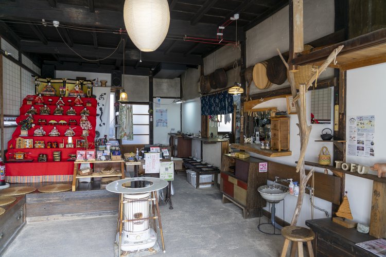 入り口を開けたら土間が現れる。右側の厨房ではスタッフさんたちが忙しく調理中。