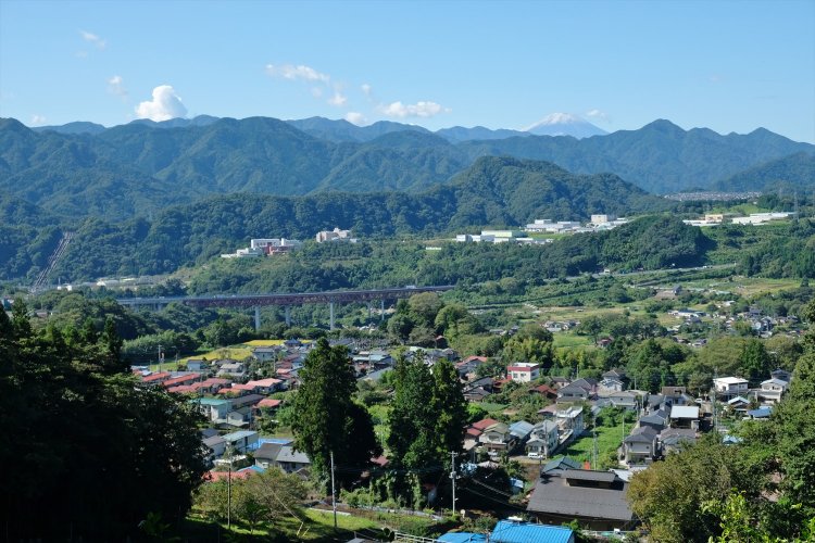 上野原霊園からの眺望。手前に中央自動車道、富士山の右手の小高い山は倉岳山。