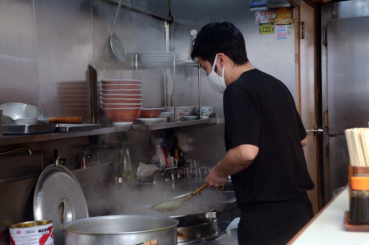 オーダーが入ると、威勢よく調理を開始した小林さん。平網で麺を器用にすくい上げて、丁寧に湯切りしていく。