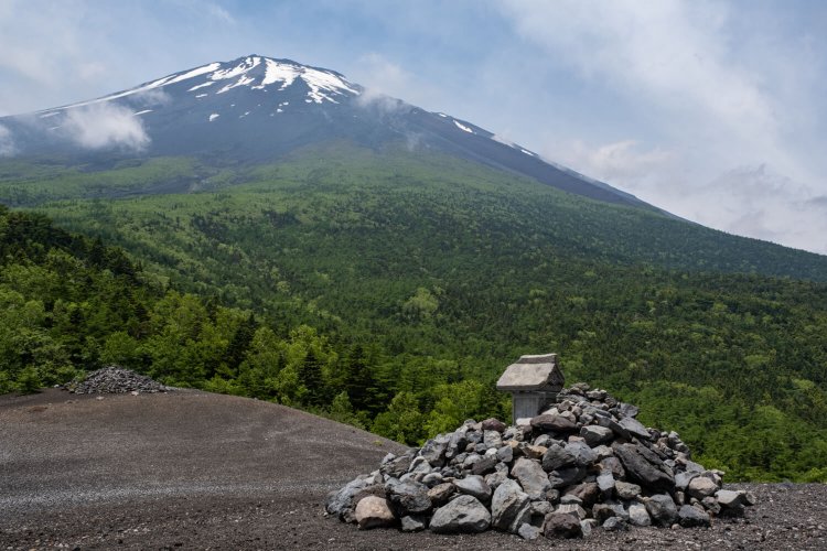 砂礫（されき）に覆われ荒涼とした光景が広がる小富士から富士山の山頂方面を仰ぎ見る。