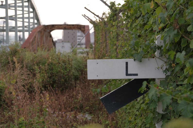 瑞穂橋と基地ゲートに挟まれて踏切跡があり勾配標も草に埋もれつつあった。 