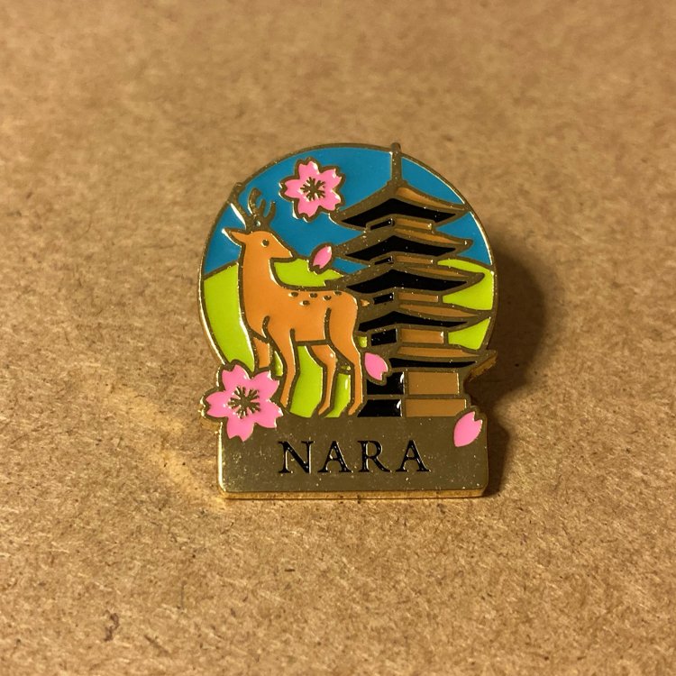 金属の凹面に色を入れたピンバッジ。カラフルな印象