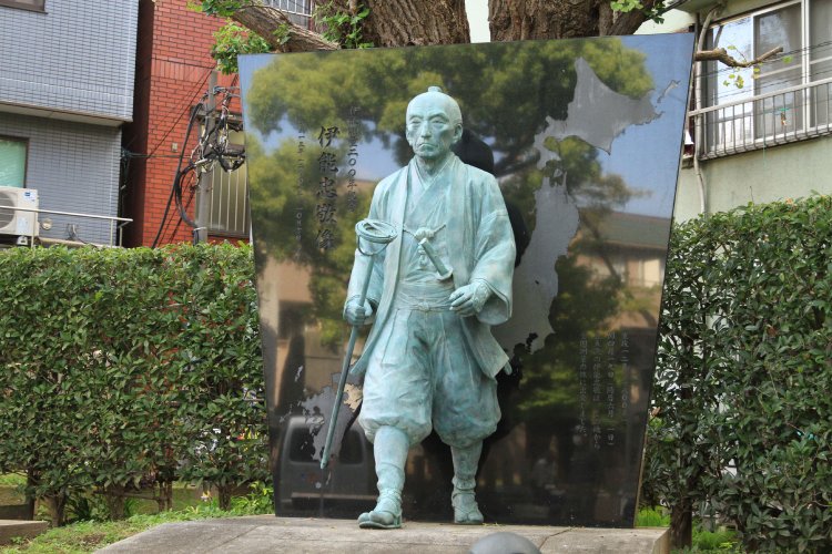 鳥居をくぐって左側に立つ伊能忠敬像。今にも旅へ歩き出しそう。