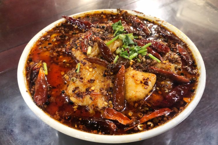 本四川風魚の煮込みはラーメンどんぶりのような器になみなみと入って1380円。四川省の夏は高温多湿で、冬は寒い。食欲アップと健康増進のためにスパイスたっぷりの料理が発達したといわれている。