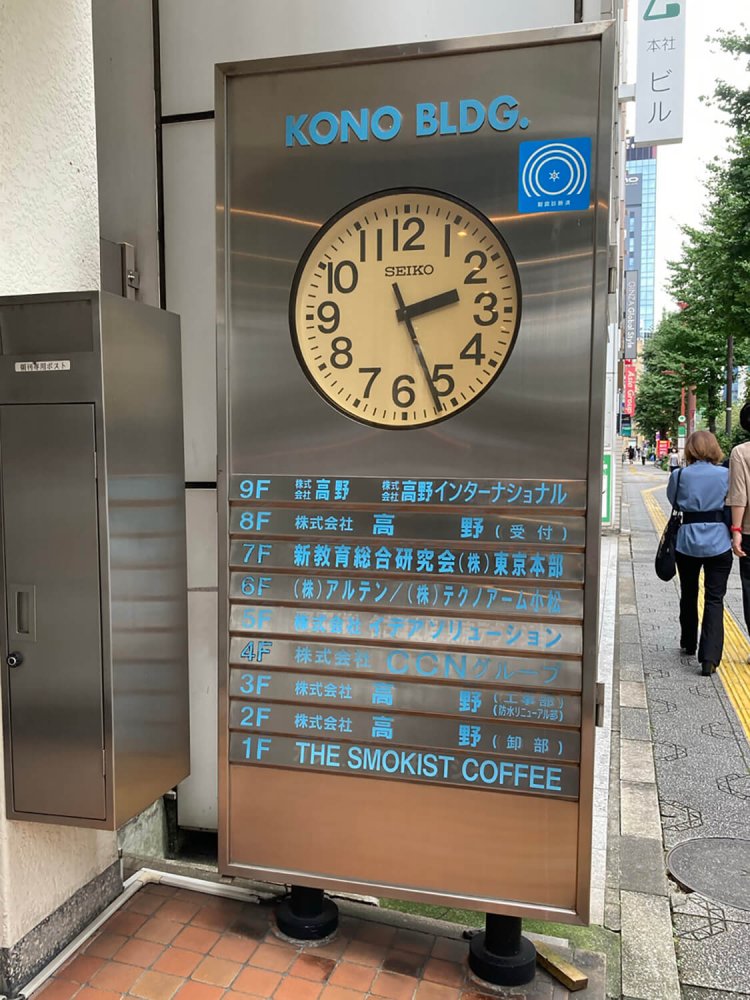 神保町のビルに設置された時計。フロア案内と一体型。