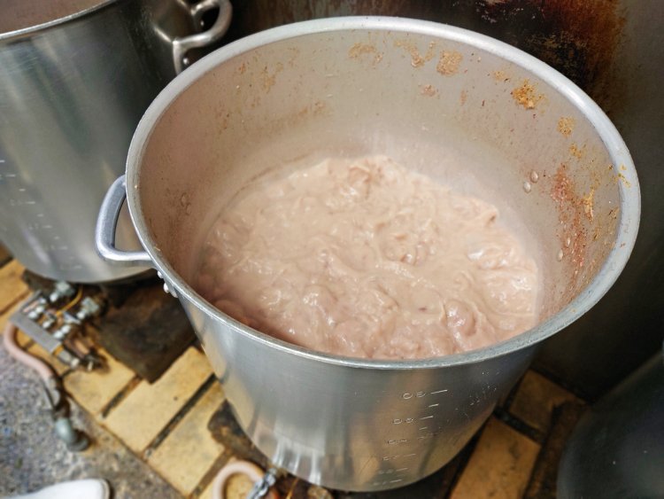 大きな寸胴にゲンコツ、背ガラ、鶏ガラを入れ、長いエンマ棒で攪拌しながら長時間煮込むことで旨味が凝縮。