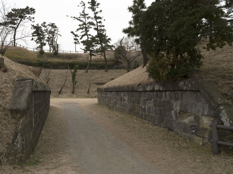 入口部分に残る土塁の石垣部分。車一台分の幅だ。
