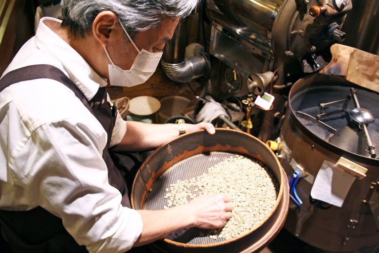 焙煎機に入れる前に欠点豆を取り除く。この作業は焙煎後にも行う。