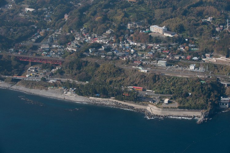 根府川駅の空撮。2011年12月15日撮影。関東大震災発生時、駅や左手の白糸川橋梁、周辺の集落は地滑りと土石流に飲まれた。駅と列車はこの相模湾の海中に沈んだ。
