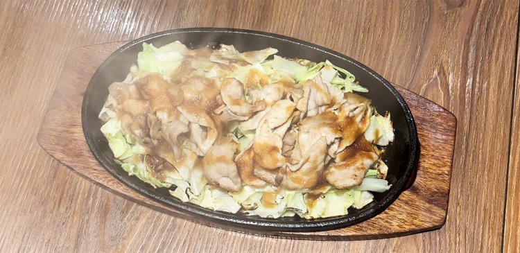 アッツアツの鉄板に特製の玉ねぎソースをかけた途端、湯気が視界を遮る！　肉と野菜とソースの相まった香りが食欲をそそる。