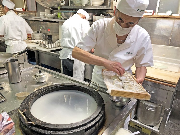 餃子を投入する前に羽になる小麦粉の入った水を鍋に張っておくのが『おけ以』流。