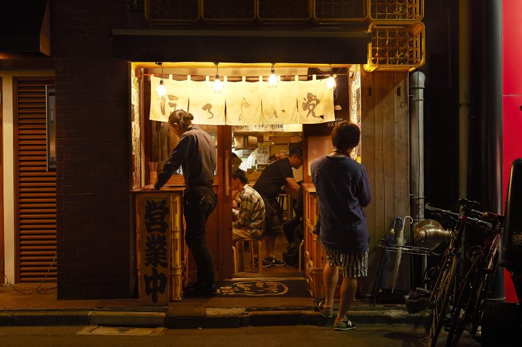 店名が書かれたのれんに電球の灯りが、大衆的な雰囲気を演出している。