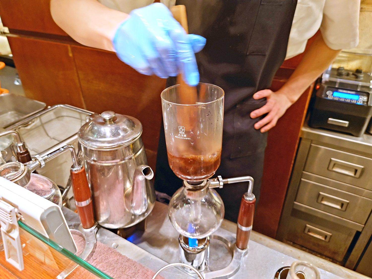 サイフォンでコーヒーの粉とお湯をなじませるように撹拌（かくはん）。