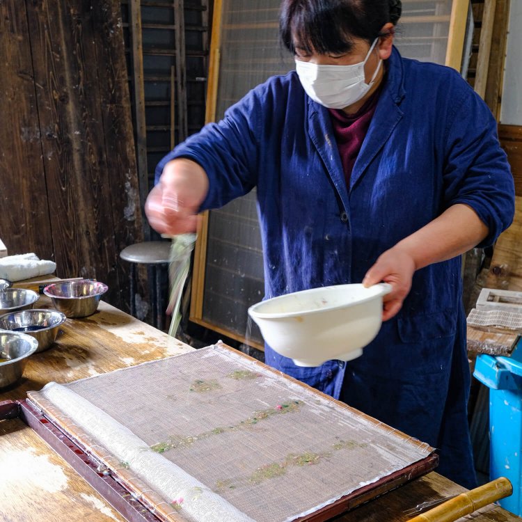 漉きあげたばかりの和紙に模様付けを施していく。