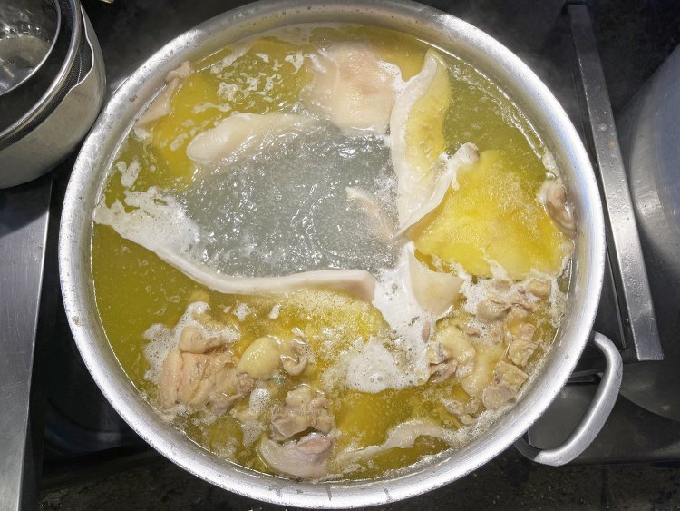 トンコツなどをコトコトと炊き、スープを濁らせないよう細心の注意を払う。