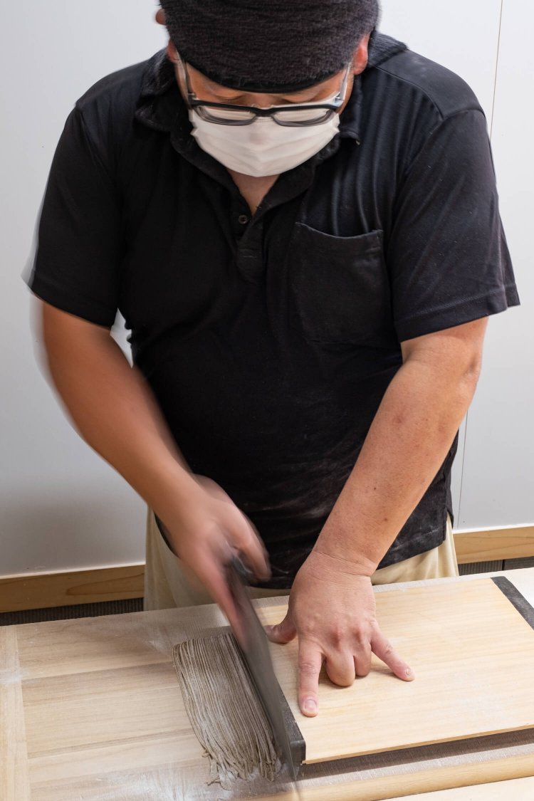 タイミングがよければ、店舗内のテーブル席からそばを打つ様子を窓ガラス越しに見られる。