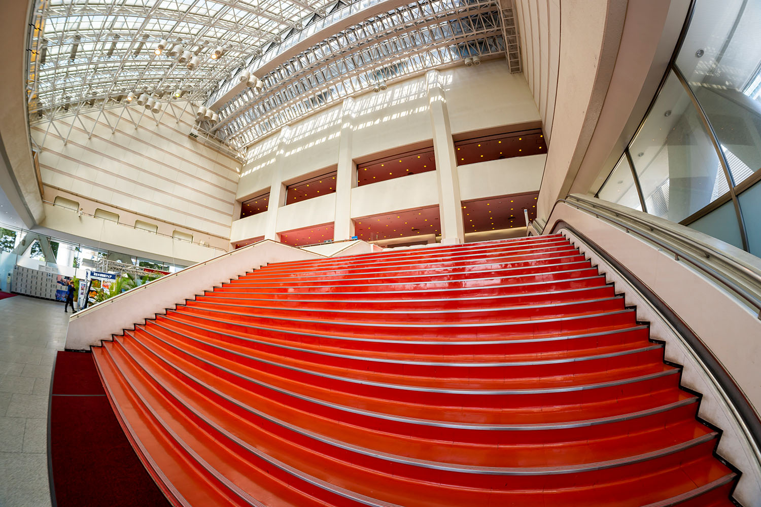 4階分吹き抜けのアトリウムと赤いビニルタイルの大階段。