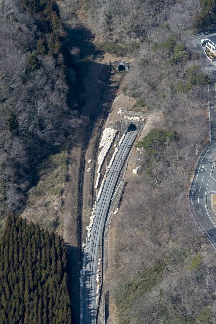 竜田側。現行線の真新しいバラストが目を引く。旧線は長年藪の中であったが、上空から路盤も坑門もはっきりと確認できた。このような位置関係だったのだ。まるで旧線も整備されて線路を敷設しそうな勢いを感じた。