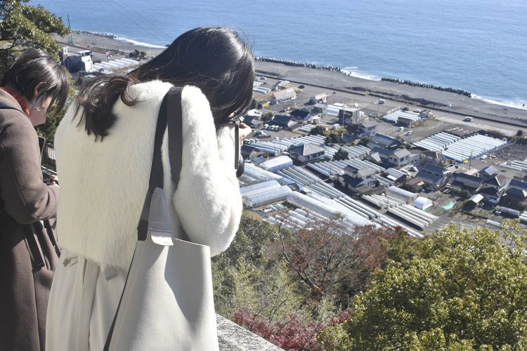 身を乗り出すようにしてつづら折れの石段を撮影するちょりんたさん。