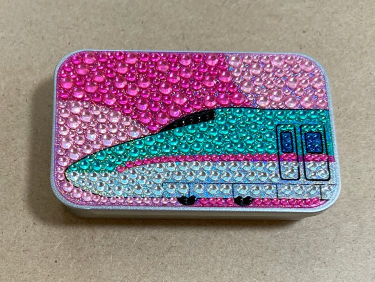 E5系の缶。背景のピンクと合わさるとポップな印象。