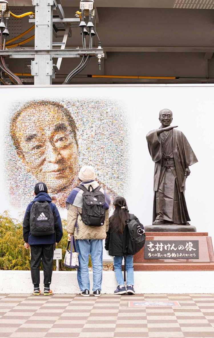 西武線東村山駅東口に立つ志村けんの像。穏やかな笑顔を浮かべ、道行く人々にアイーン！