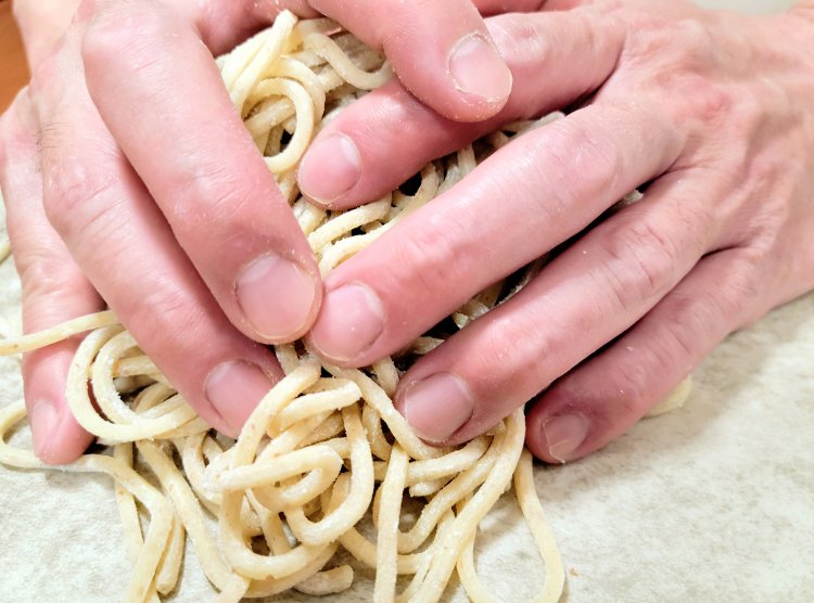 汁なし担々麵の中太麺は1玉ずつ丁寧に手揉みする。