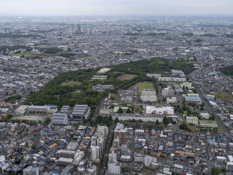 上空南側から見る。手前右が航空自衛隊府中基地で左が学校。終戦後はこのいびつな台形の土地が米軍府中基地となっていた。2021/5/11撮影