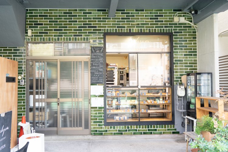 深みのある緑色を組み合わせたタイルが印象的な店構え。玄関用の引き戸が懐かしい雰囲気だ。