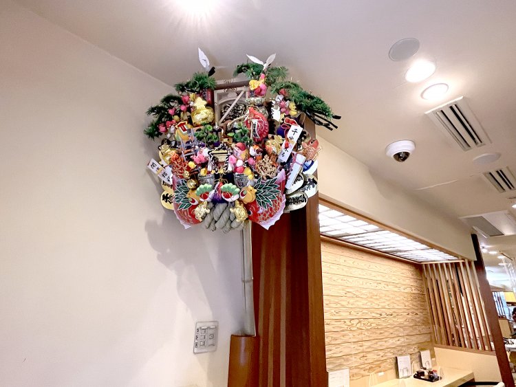 店の入り口には大きな熊手。見上げる方にもご利益を分けてくれそうだ。