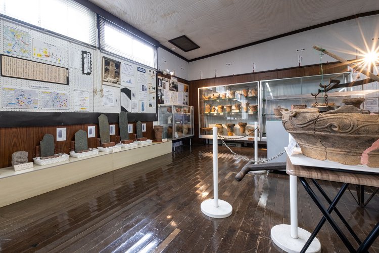 出土した土器や中世の板碑がずらりと並ぶ歴史資料コーナー。