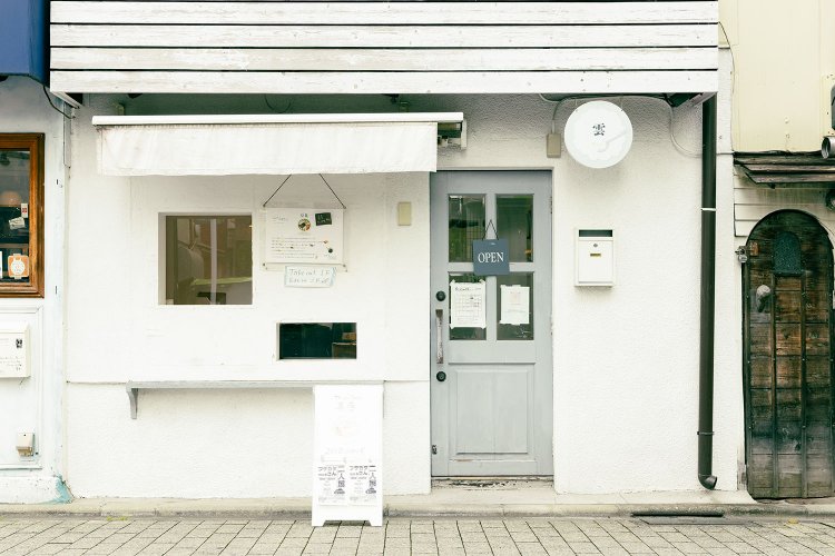 西荻窪駅の高架下にあり、白い壁にブルーグレーの扉が目印。