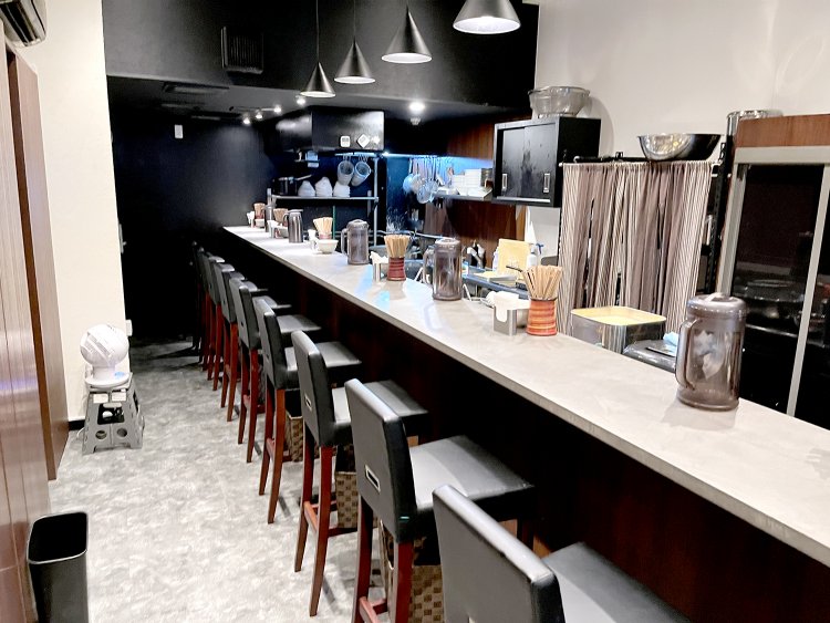 席間がゆったり。オープンキッチンだから調理の様子もバッチリ見られる。