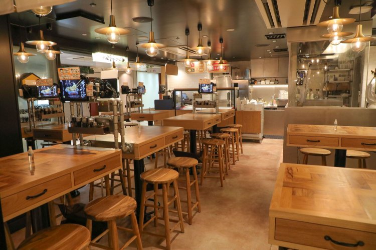 店内中央には餃子の焼き場があり、どの席からも見えるのが魅力。テー ブル席の引き出しに箸や取り皿が用意されたセルフスタイル。