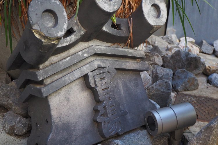 創業当時の瓦が入り口の脇に飾られている。