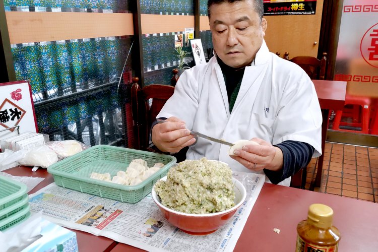 手作業で餃子を包む店長の中西孝幸さん。夜の仕込みで大忙しの中、快く取材に付き合ってくれた。