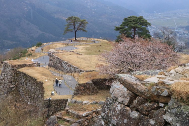 築城は永享3年（1413）に開始と伝わる。野面積みの石垣は北・南千畳で異なる表情。