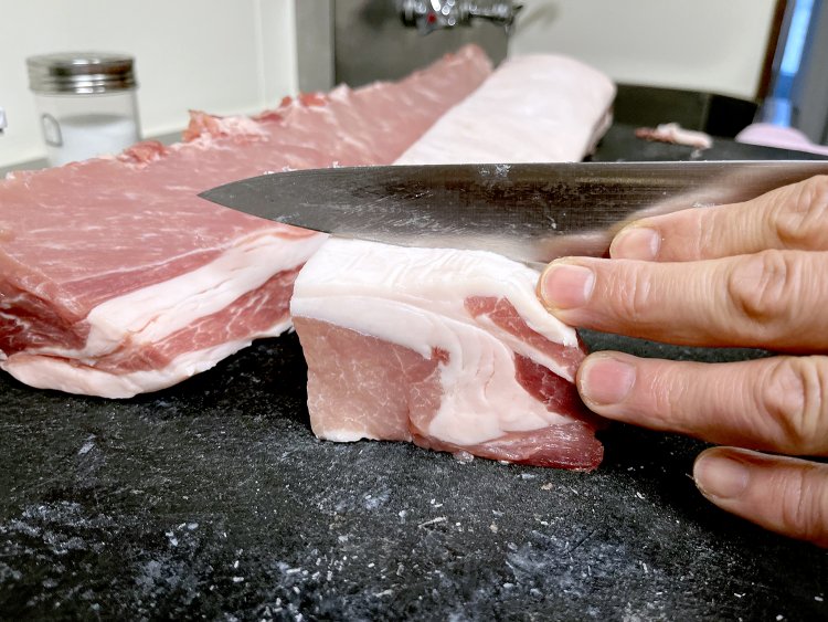 ロース肉を手切りでカットしていく。赤身は淡いピンク色で脂身も透明感がある。