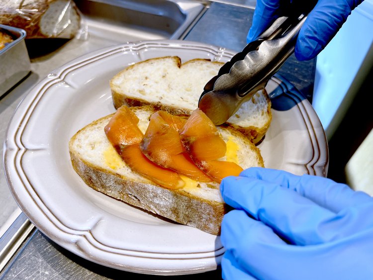 スライスしたパンの上に甘酸っぱいソースをかけその上にスモークサーモンを飾る。