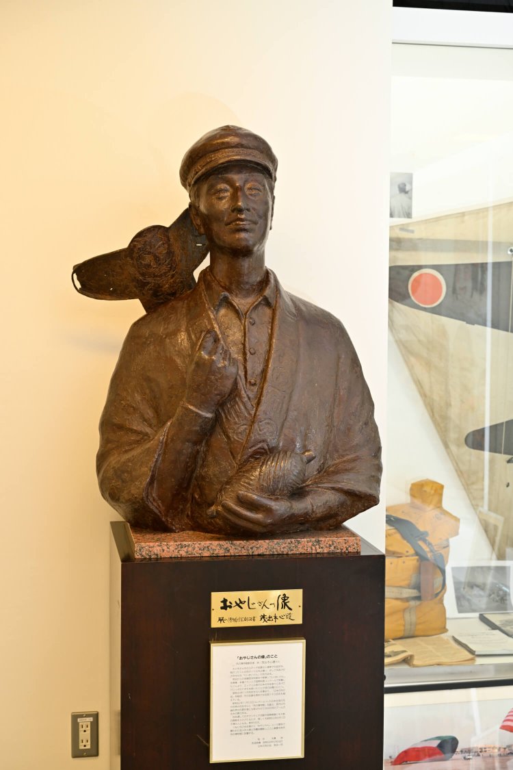 創設者 茂出木心護の像。「日本の凧にはアブや蝉のモチーフも多いんだ」。